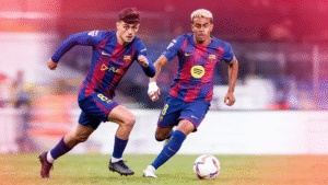 Two young midfield and winger players wearing Barcelona style jerseys during a match